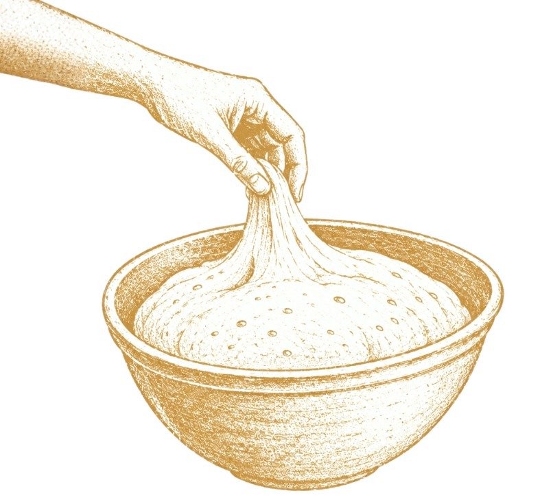 Hand lifting challah dough from a bowl